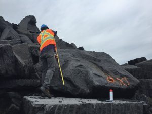 PICTURE COURTESY ROBERT CRAM: A Quebec quarry worker marks granite destined to become part seating, part art installation in four parkettes set to launch on Bloor Street in 2018.